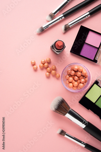 Creative concept beauty fashion photo of cosmetic product make up brushes kit on pink background.