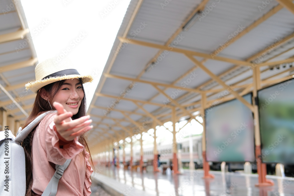 woman traveler with backpack stretching hand for holding at train station. trip journey travel