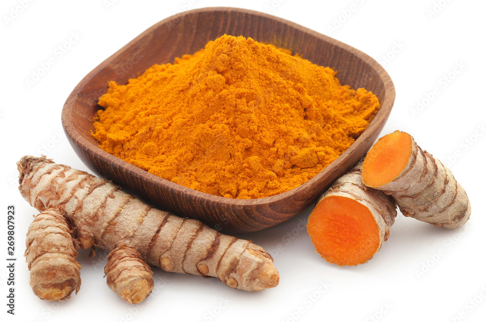 Raw turmeric with powder in a bowl Raw turmeric with powder in a bowl