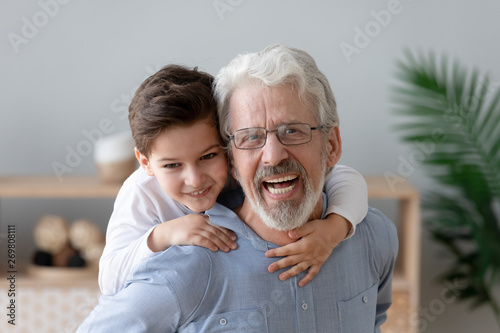 Tela Portrait of happy grandson have fun piggyback smiling grandfather