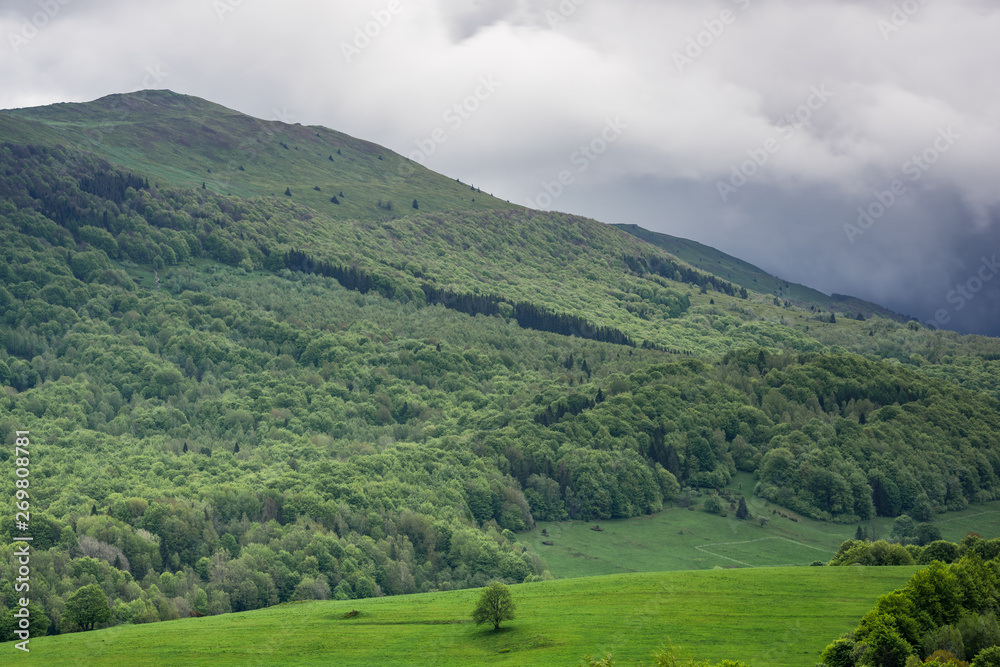 Dramatic stormy weather clouds over peaks in Bieszczady National Park, Poland