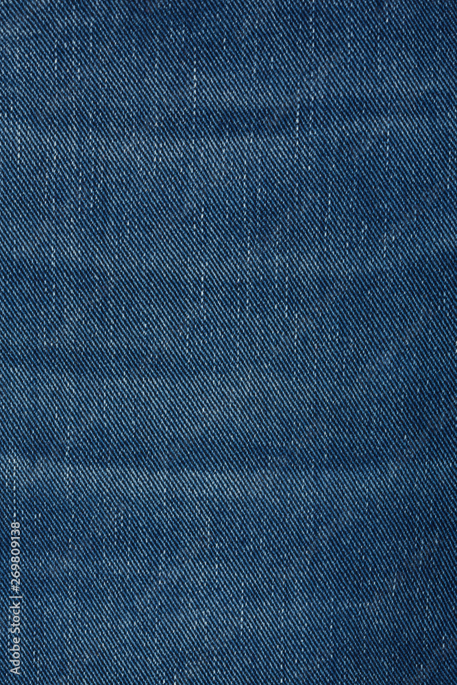 Denim jeans texture background with torn. The texture of the colored cotton fabric. Stitched texture jeans background. Fashion jeans button. Pocket and rivet on jeans. Fiber and fabric structure. Denim jeans texture background with torn. The texture of the colored cotton fabric. Stitched texture jeans background. Fashion jeans button. Pocket and rivet on jeans. Fiber and fabric structure.