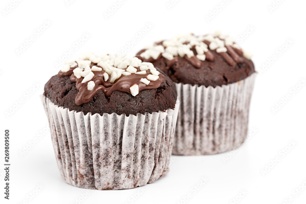 Tasty chocolate cupcakes on white background. Chocolate caramel cupcake and butterscotch syrup. Chocolate cupcake isolated on white. Tasty chocolate cupcakes on white background. Chocolate caramel cupcake and butterscotch syrup. Chocolate cupcake isolated on white.