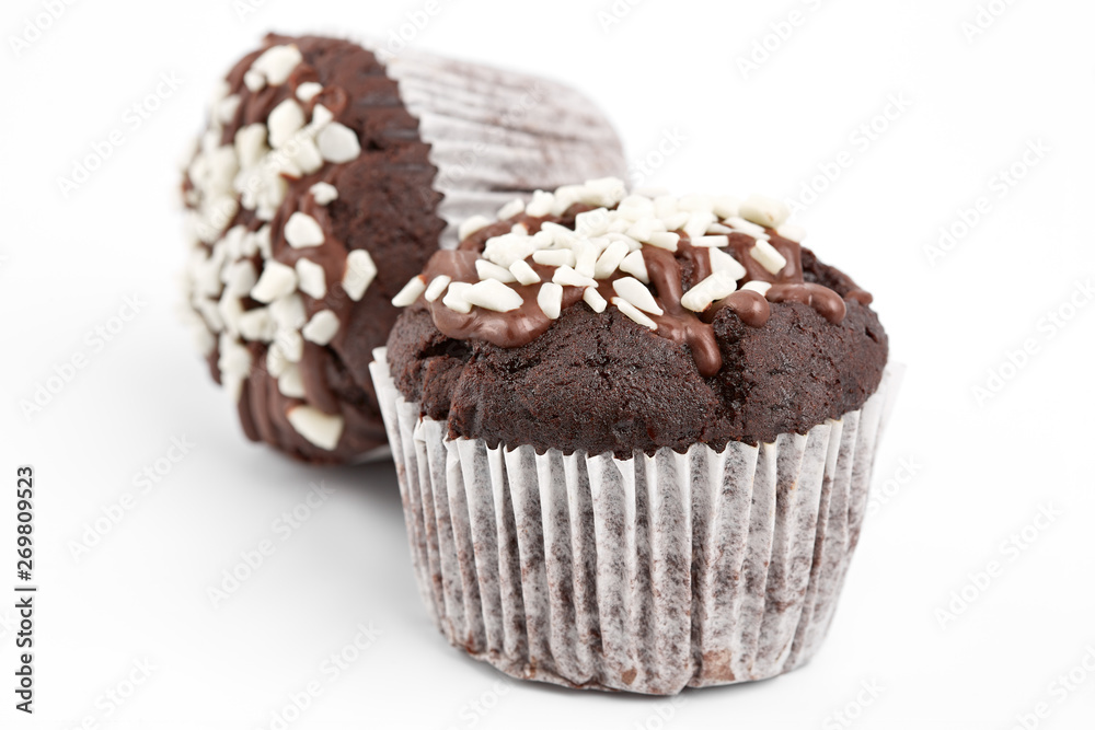 Tasty chocolate cupcakes on white background. Chocolate caramel cupcake and butterscotch syrup. Chocolate cupcake isolated on white. Tasty chocolate cupcakes on white background. Chocolate caramel cupcake and butterscotch syrup. Chocolate cupcake isolated on white.