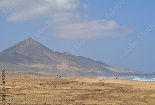 Beautiful sandy ocean beach on a background of mountains. Fuerteventura Canary Islands, Spain