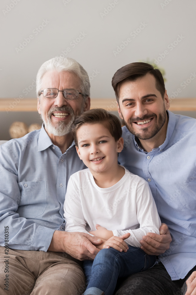 Portrait of three generations of men posing at home