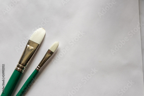 Premium-Pinsel auf weißem Blatt Papier warten auf den Einsatz im Atelier eines Malers oder Künstlers