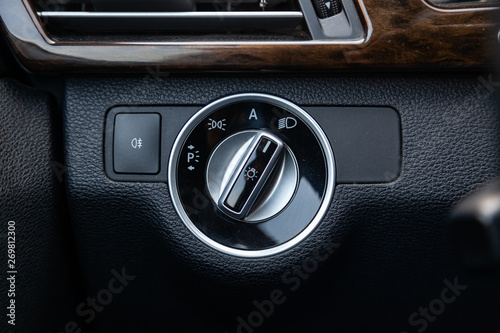 Bilde på lerret The dashboard of the car's interior is black with a dipped headlamp switch and side lights with a light sensor and automatic dimming and fog light button