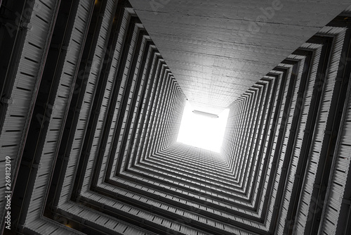Fototapeta Naklejka Na Ścianę i Meble -  Abstract building facade concrete void or tunnel with natural light in the end / architecture design / abstract concept / background texture