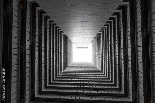 Fototapeta Naklejka Na Ścianę i Meble -  Abstract building facade concrete void or tunnel with natural light in the end / architecture design / abstract concept / background texture