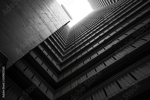 Fototapeta Naklejka Na Ścianę i Meble -  Abstract building facade concrete void or tunnel with natural light in the end in twist view/ architecture design / abstract concept / background texture