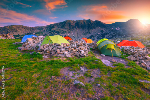 Camping place with colorful tents at sunset  Retezat mountains  Romania