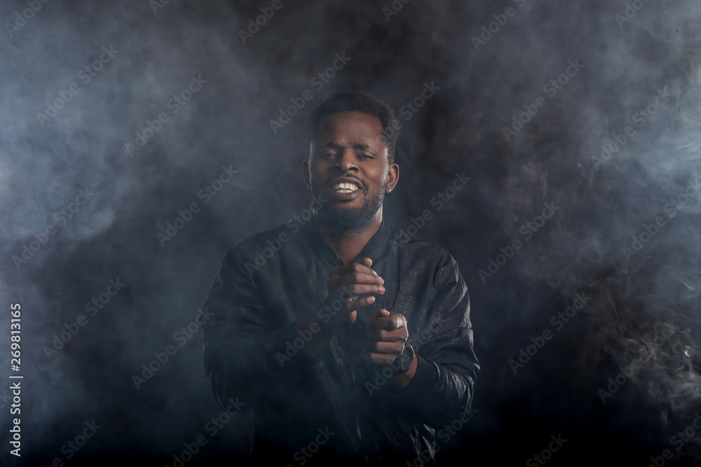 Young handsome african american man dancing in dark Young handsome african american man dancing in dark