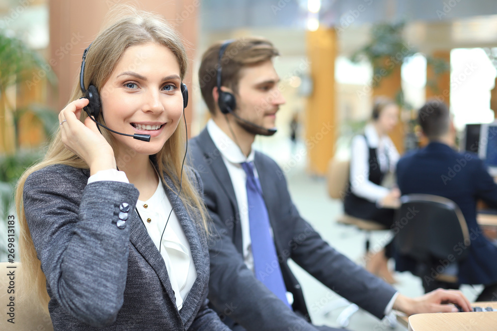 Female customer support operator with headset and smiling. Female customer support operator with headset and smiling.