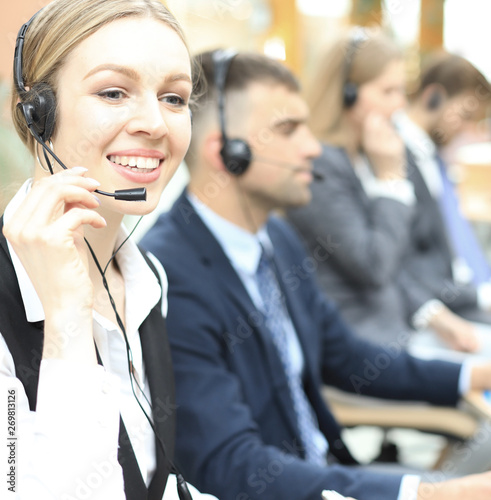 Female customer support operator with headset and smiling.