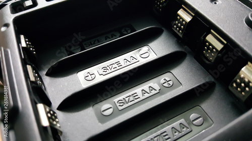 AA battery charge sign or symbol in the black plastic equipment slot that ready to install 4 batteries