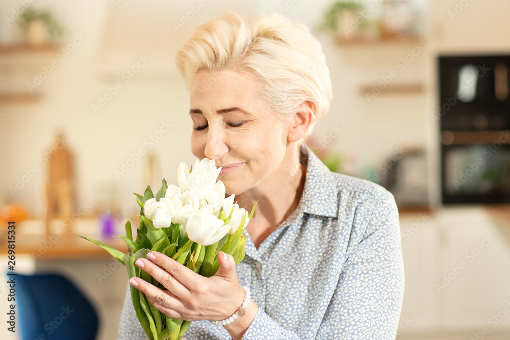Middle age woman holding bouquet of tulips. Middle age woman holding bouquet of tulips.