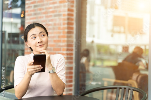 Happy woman using smart phone in the city