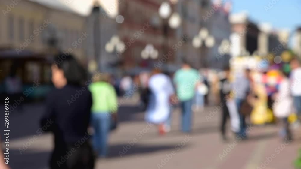 Blurred crowd of tourists people walking along the street of the old city Blurred crowd of tourists people walking along the street of the old city