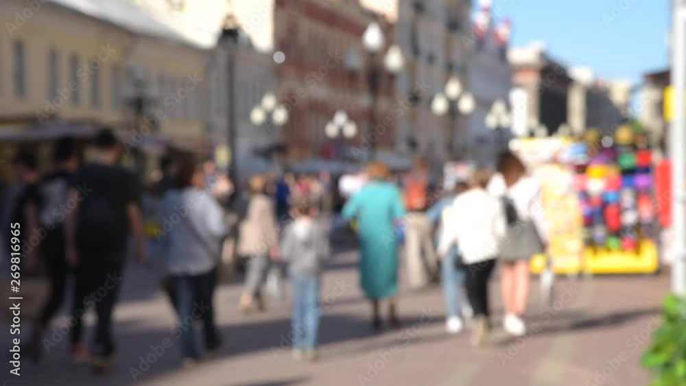 Blurred crowd of tourists people walking along the street of the old city Blurred crowd of tourists people walking along the street of the old city