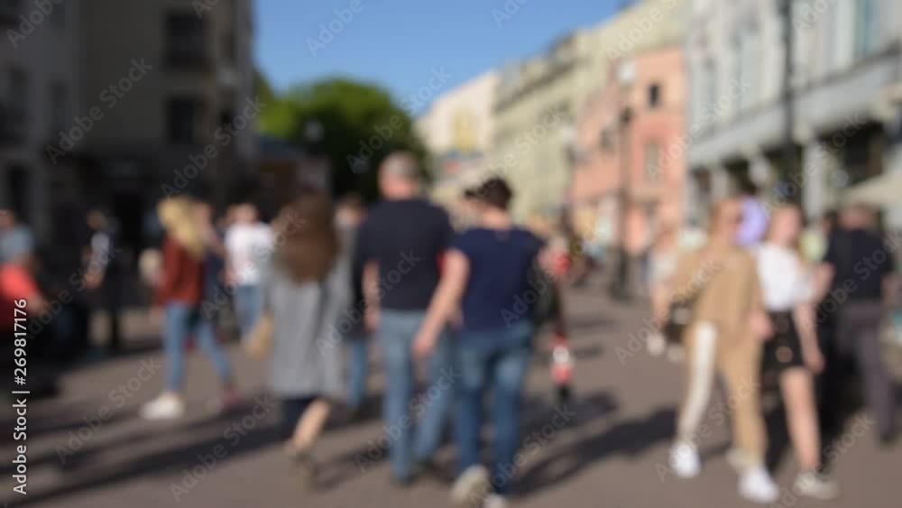 Blurred crowd of tourists people walking along the street of the old city Blurred crowd of tourists people walking along the street of the old city
