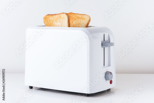 Toaster with  roasted toast bread on white background, close up