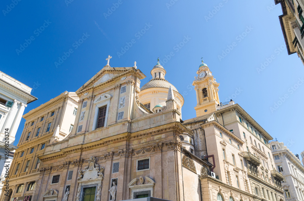 Facade and dome of Chiesa dei Santi Ambrogio e Andrea detta del Gesu catholic church on Piazza Giacomo Matteotti square in historical centre of old european city Genoa Genova, Liguria, Italy
