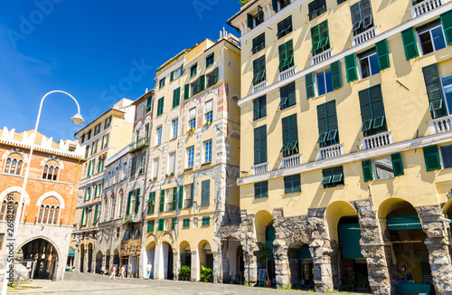Fototapeta Naklejka Na Ścianę i Meble -  Buildings with arches, archways, portico and shutters on windows on Piazza Della Raibetta square in historical centre of old european city Genoa Genova, Liguria, Italy