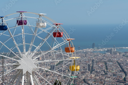 Ferris Wheel at Tibidabo amusement park in Barcelona with city view at the background