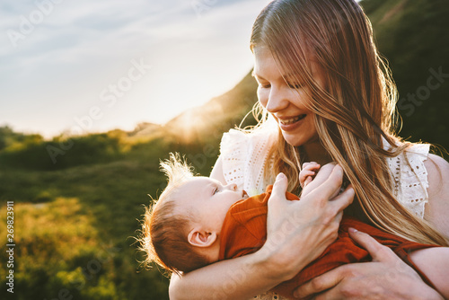 Happy mother walking with infant baby outdoor family lifestyle mom holding child maternity Mothers day summer travel vacations