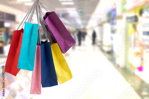 many colorful shopping bags on the background of the shopping center.