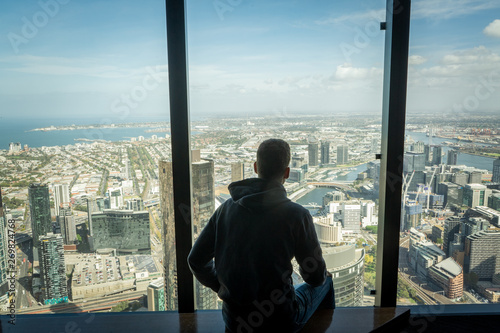 Boy on window with Melbourne skyline © Florian