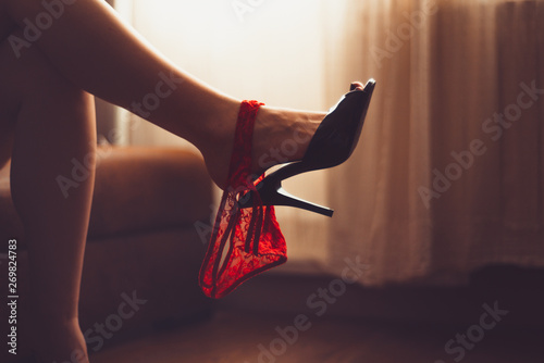 sexy woman legs in high heel mules. women fetish shoe dangling on feet. shoeplay, shoe and foot fetish. beautiful woman flirting. woman's heel slippers