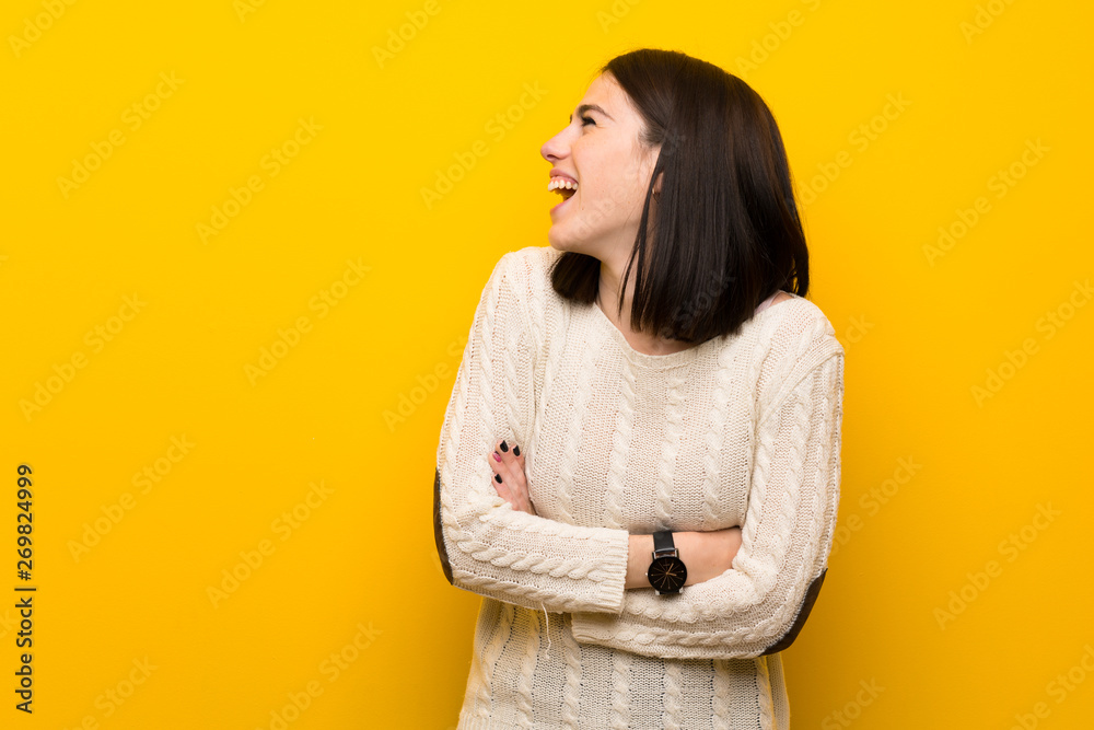 Young woman over isolated yellow wall happy and smiling Young woman over isolated yellow wall happy and smiling
