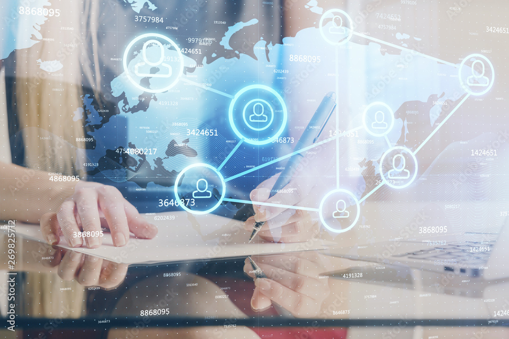 Social network theme hologram over hands taking notes background. Concept of global international people connect. Double exposure Social network theme hologram over hands taking notes background. Concept of global international people connect. Double exposure