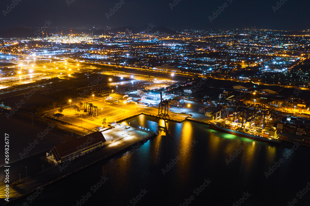 factory area and terminal shipping port cargo container import and export in thailand at night over lighting