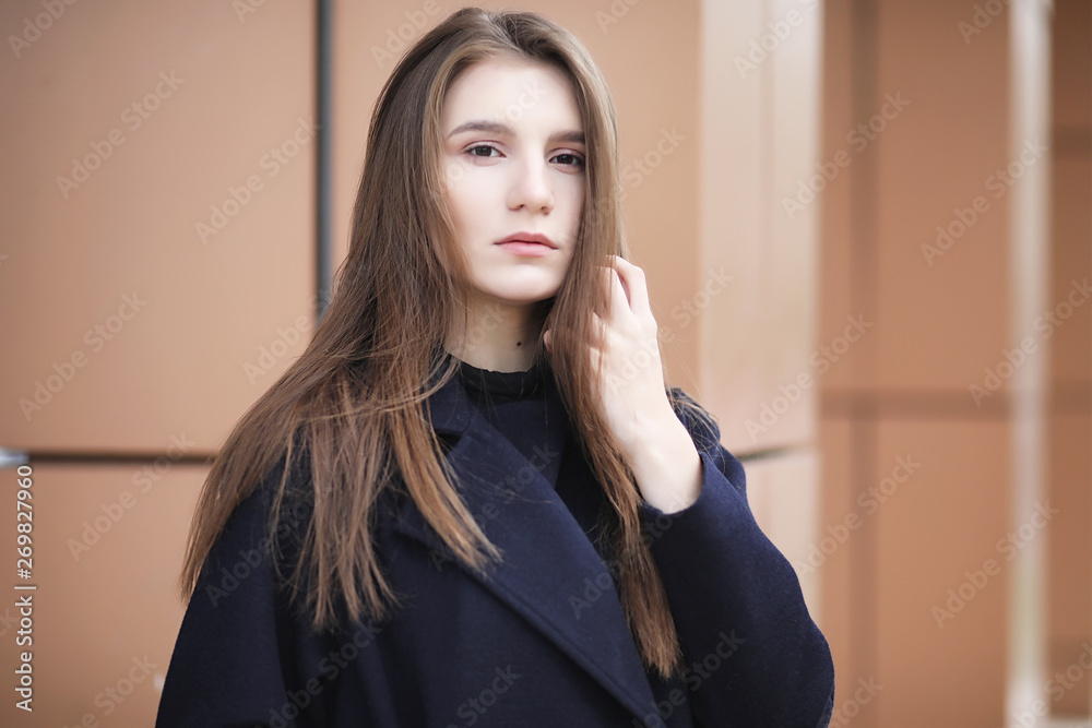 Beautiful girl in a coat in business downtown Beautiful girl in a coat in business downtown