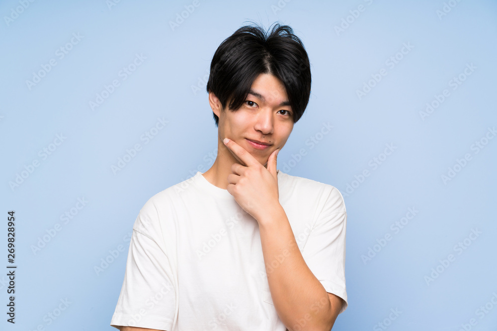 Asian man on isolated blue background laughing Asian man on isolated blue background laughing