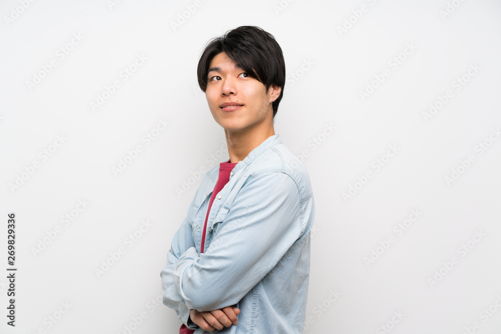 Asian man on isolated white background with arms crossed and happy Asian man on isolated white background with arms crossed and happy