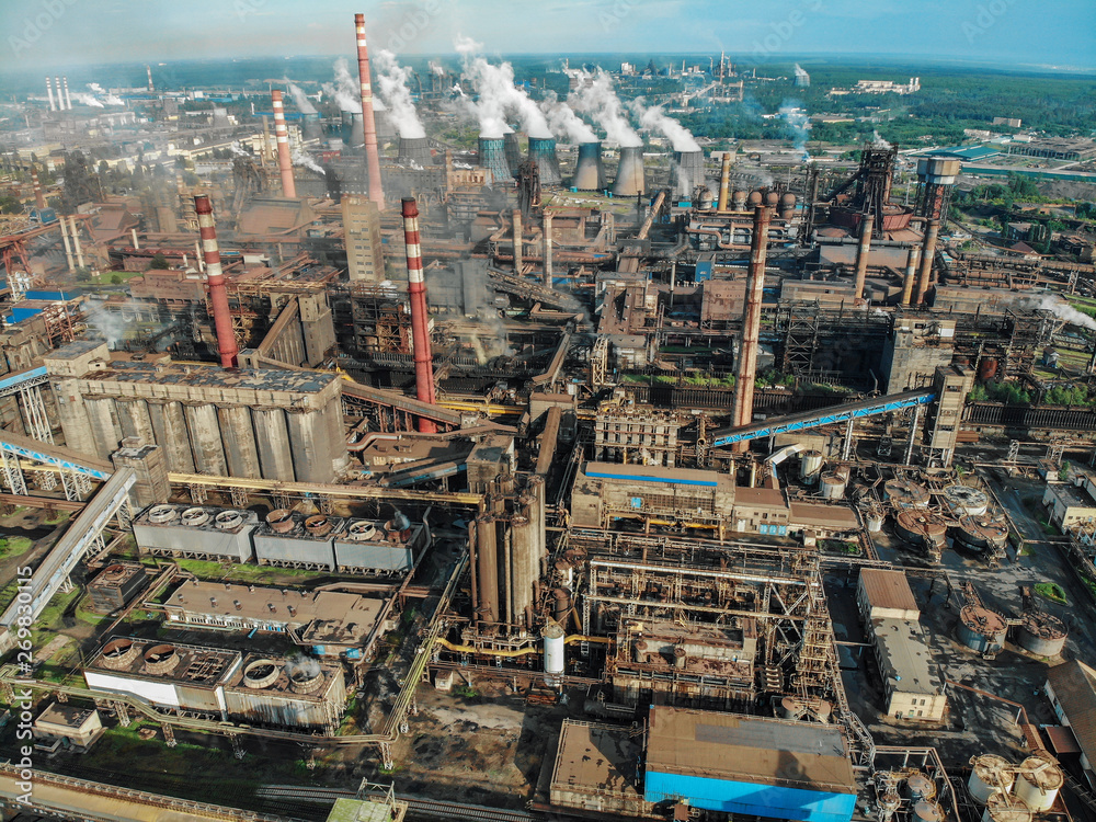 Aerial view of Factory or Plant Industrial Area with many pipes or chimneys with smoke. Heavy industry of Metallurgical Production industry landscape