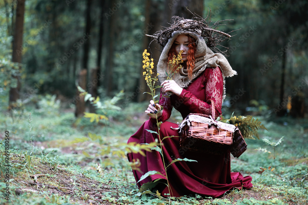 The red-haired witch holds a ritual with a crystal ball The red-haired witch holds a ritual with a crystal ball