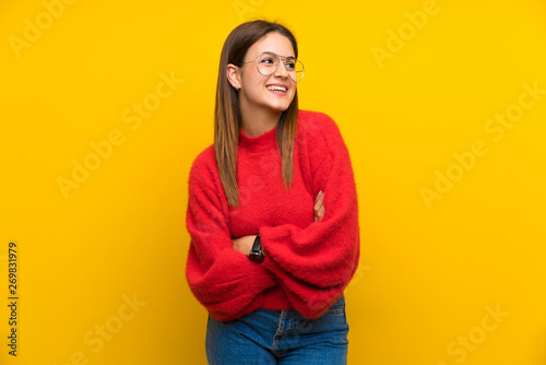 Young woman over isolated yellow wall laughing © luismolinero