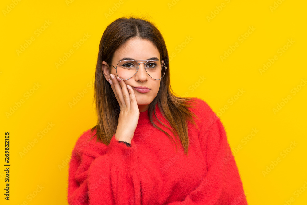 Young woman over isolated yellow wall unhappy and frustrated Young woman over isolated yellow wall unhappy and frustrated