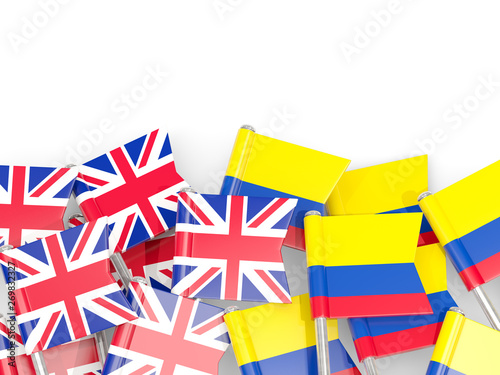 Pins with flags of UK and colombia isolated on white.