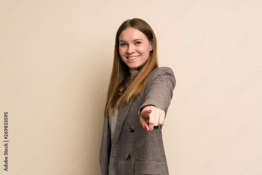 Young business woman points finger at you with a confident expression Young business woman points finger at you with a confident expression