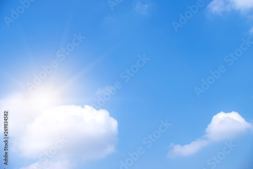 Beautiful white clouds with sun on blue sky.Color shade gradient from white to blue for background wallpaper.