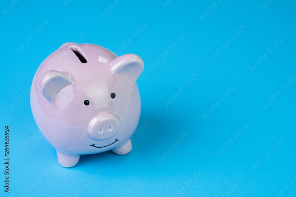 Financial, savings, budget, cost or investment concept, white happy piggy bank on clean blue background with copy space