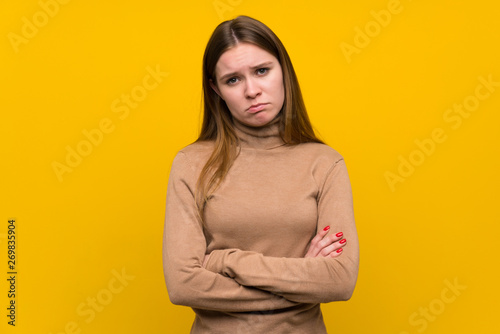 Young woman over colorful background sad © luismolinero