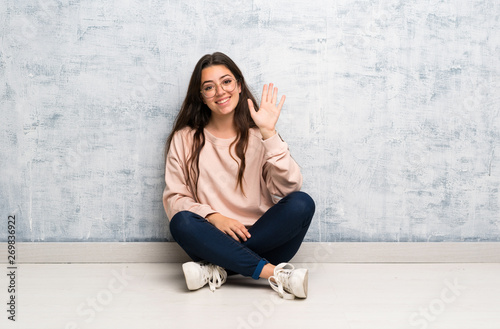 Teenager student girl studying in a table saluting with hand with happy expression Free Download Teenager student girl studying in a table saluting with hand with happy expression - GFXLoad