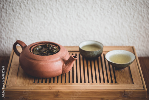 Chinese Gongfu tea ceremony with Oolong tea on chaban table photo